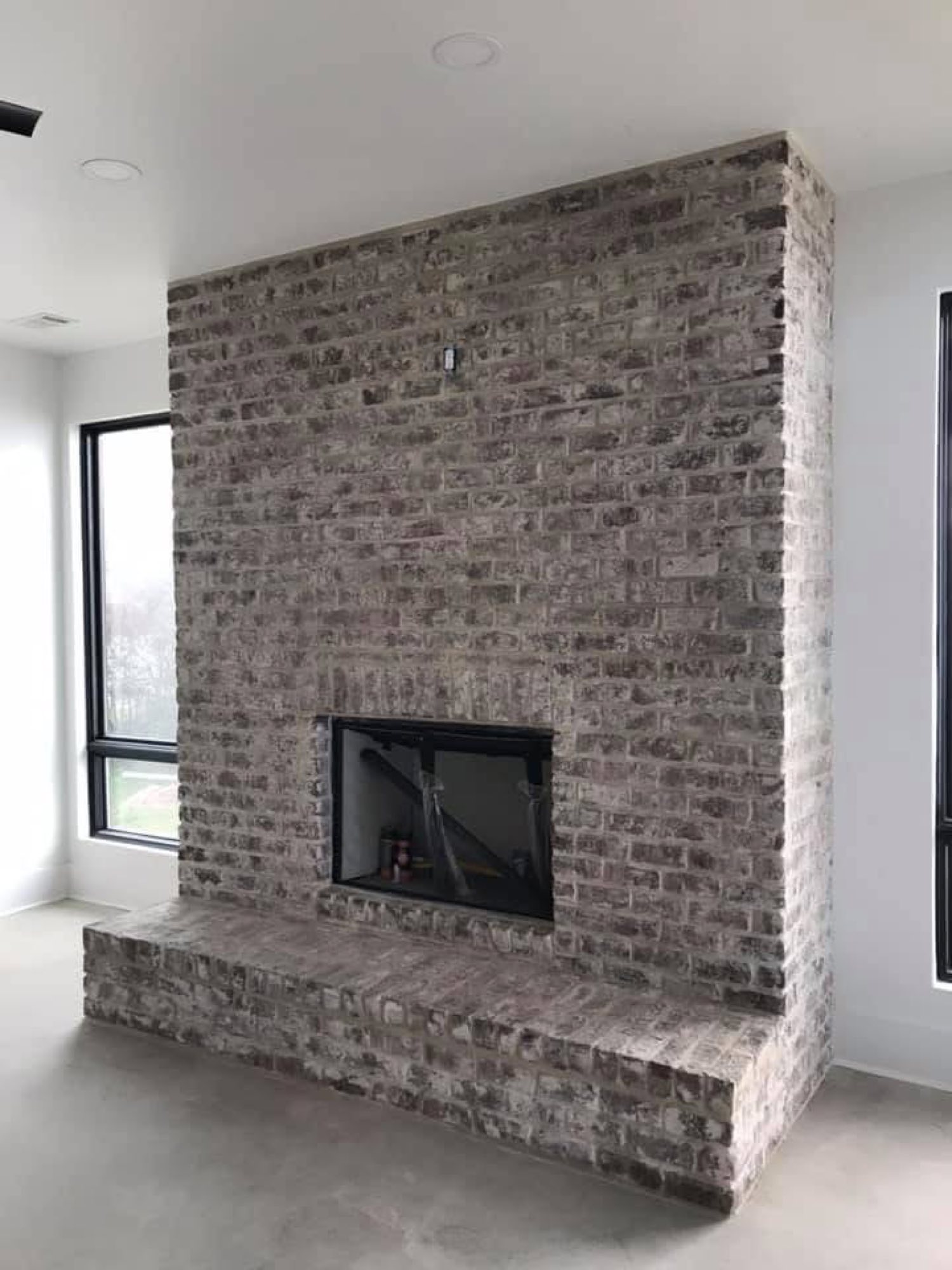 Floor-to-ceiling brick fireplace by Primestone Heritage